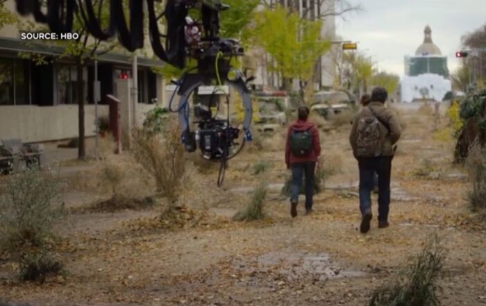 Screenshot of a scene from the show The Last of Us, featuring the Alberta Legislature building in the background.